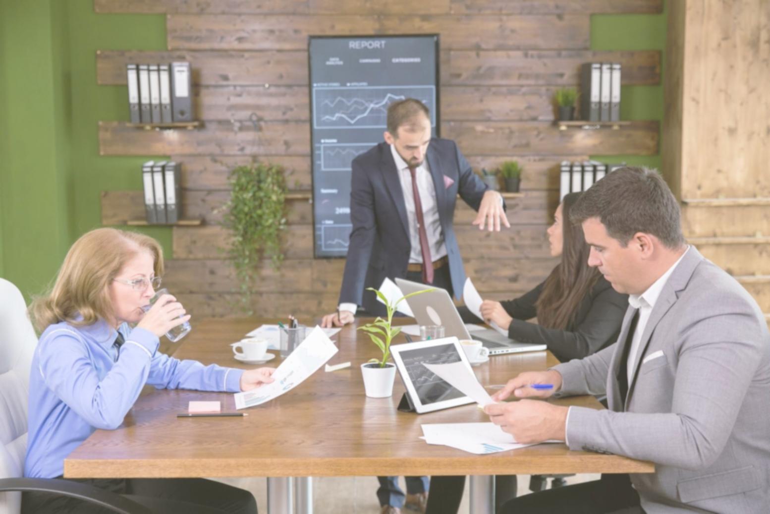 Investment evaluation team collaborating on market analysis and portfolio optimization strategies