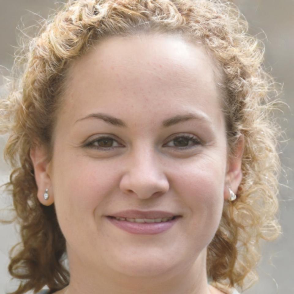 Program coordinator Sarah Chen discussing investment evaluation curriculum with prospective students during information session